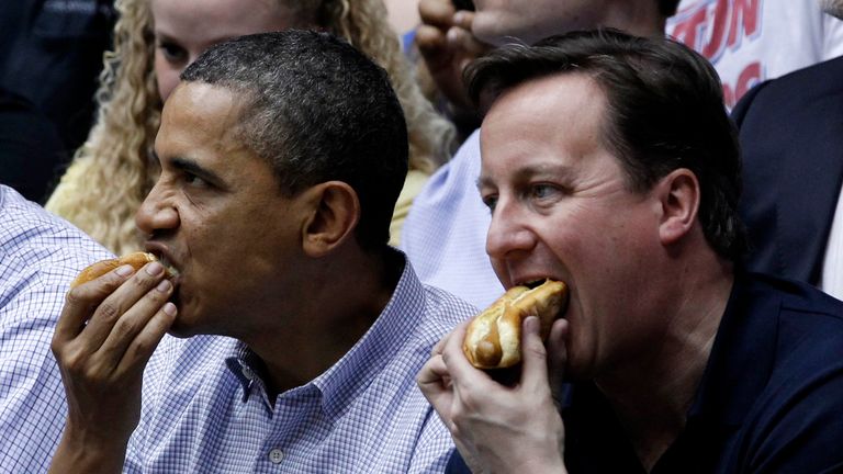 Barack Obama and David Cameron eat hot dogs at basketball game in Ohio, 2012