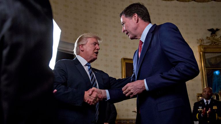 President Donald Trump shakes hands with James Comey
