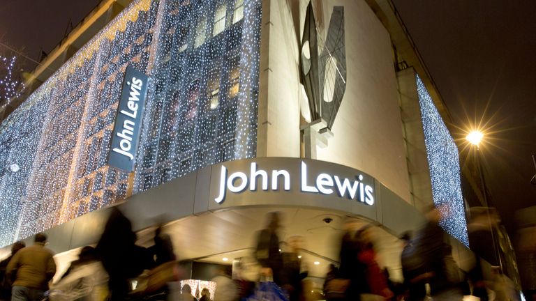 Pedestrians walk past a John Lewis store on Oxford Street, London, Britain, December 15, 2013