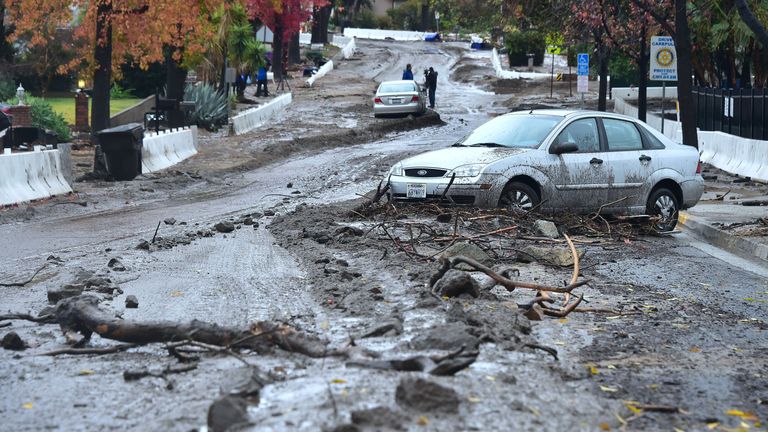 Mud and debris covers a residential road in Duarte, California
