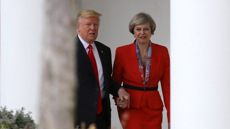 Donald Trump and Theresa May hold hands