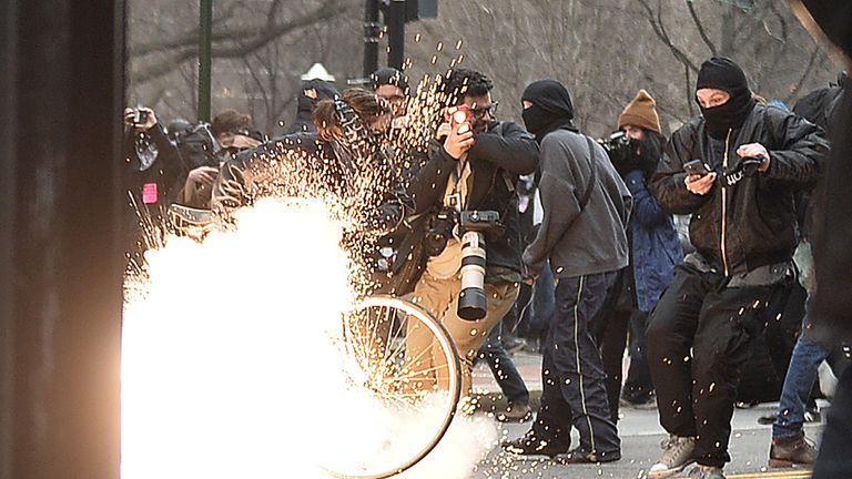 A flash-bang grenade explodes during clashes between riot police and protesters