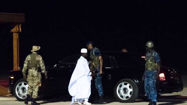 Former president Yaya Jammeh (C), the Gambia&#39;s leader for 22 years, walks towards the plane as he leaves the country on 21 January 2017 in Banjul airport.