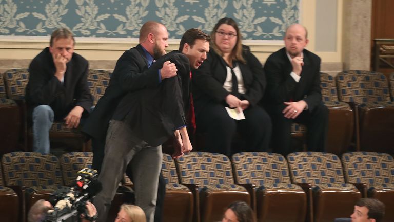 A protester is removed from the gallery  at Congress