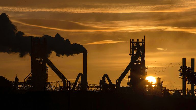 The sun rises behind the British Steel - Scunthorpe plant in north Lincolnshire, north east England on September 28, 2016