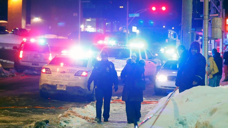 Police officers are seen near a mosque after a shooting in Quebec City, January 29, 2017. REUTERS/Mathieu Belanger
