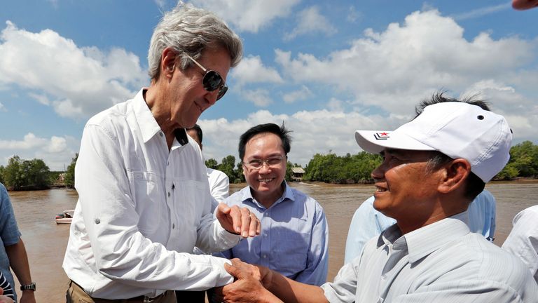 John Kerry shakes the hand of former Viet Cong soldier Vo Ban Tam
