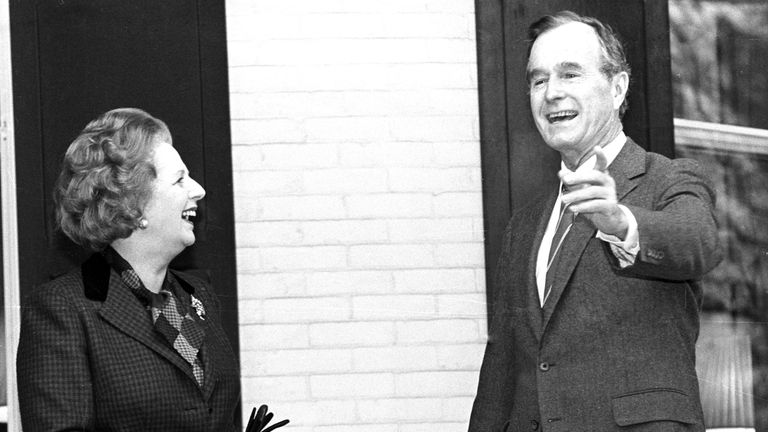 Margaret Thatcher and U.S. Vice President George Bush pause for the press on the porch of the Vice President's residence, 1986