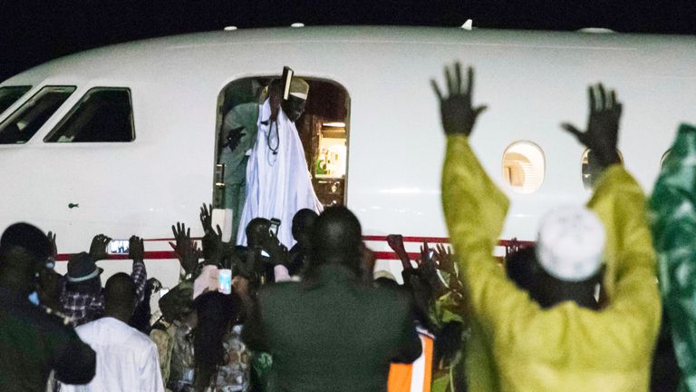 Former president Yaya Jammeh (C,up), the Gambia&#39;s leader for 22 years, waves from the plane as he leaves the country on 21 January 2017 in Banjul.