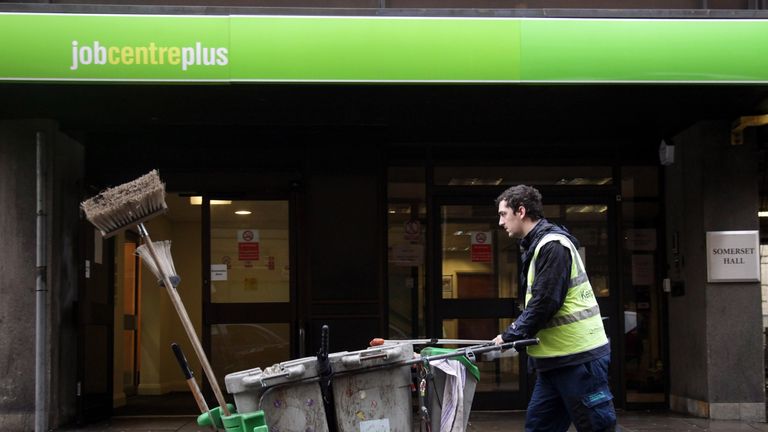 A street cleaner passes the Jobcentre Plus office on January 18, 2012 in Bath