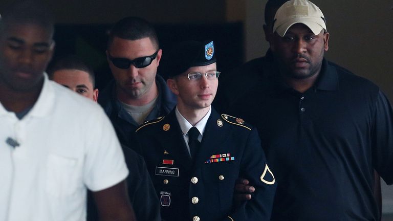 US Army Private First Class Bradley Manning is escorted out of a military court facility during the sentencing phase of his trial August 20, 2013 in Fort Meade, Maryland. Manning was found guilty of several counts under the Espionage Act, but acquitted of the most serious charge of aiding the enemy