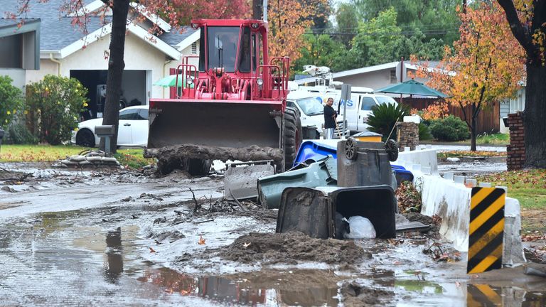 A bulldozer clears mud in Duarte, California, after a heavy storm in December