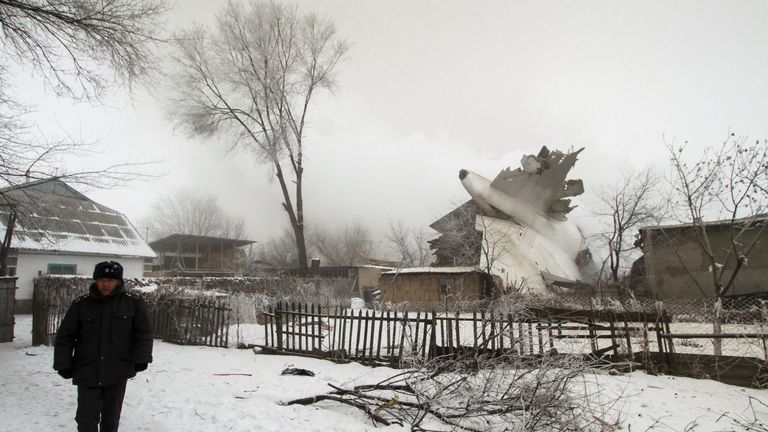 A policeman guards an area at the crash site of a Turkish cargo jet near Kyrgyzstan&#39;s Manas airport outside Bishkek