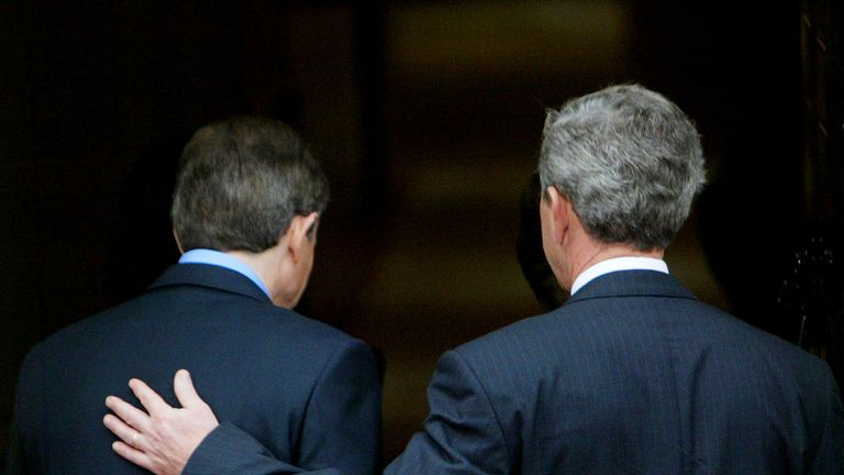 George W. Bush puts his hand on the back of Tony Blair as they enter 10 Downing Street, 2003