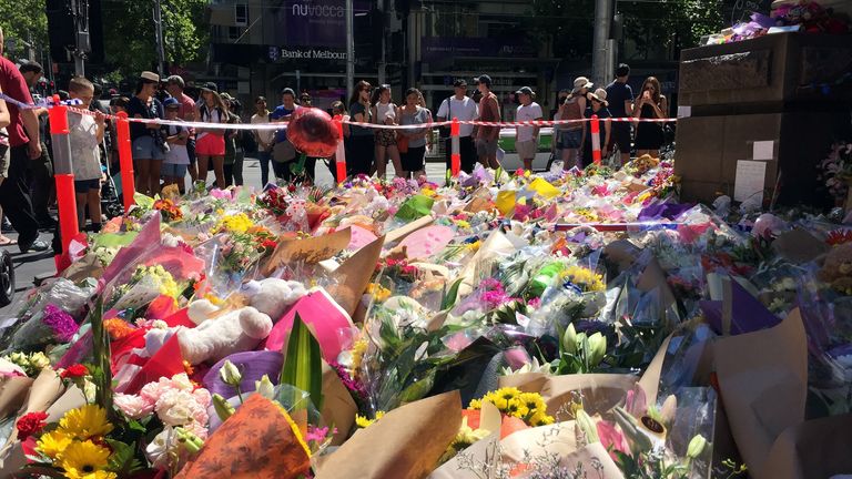 Flowers have been left in Bourke Street ahead of a vigil on Monday 