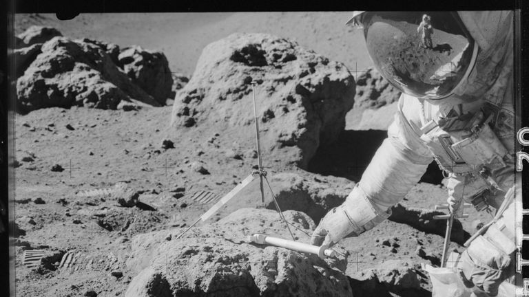 Apollo 15 commander Dave Scott takes samples at the boulder on the rim of Hadley Rille during the Apollo 15 mission in July 1971