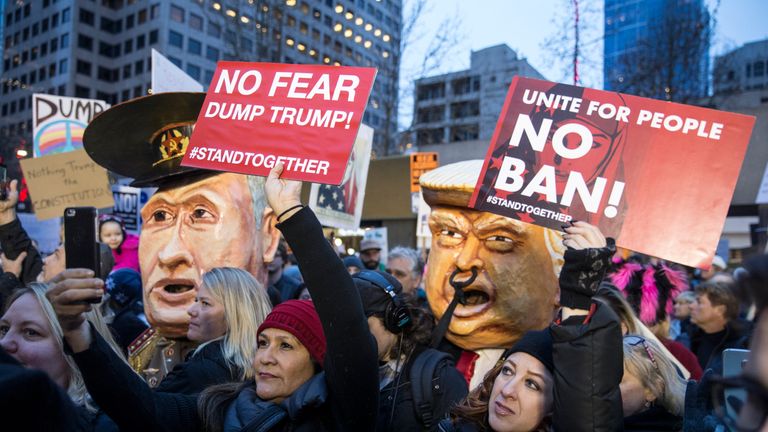 Protestors hold up signs in front of effigies of U.S. President Donald Trump and Russian President Vladimir Putin during in a demonstration on January 29, 2017 in Seattle, Washington, against Trump&#39;s executive order banning Muslims from certain countries. The rally was one of several in the area over the weekend