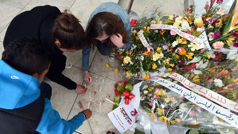 Tourists light candles at the national Bardo Museum in Tunis in memory of the victims of a jihadists attack which killed 21 people, including 20 tourists the previous week, during the official re-opening of the museum following the massacre on March 27, 2015