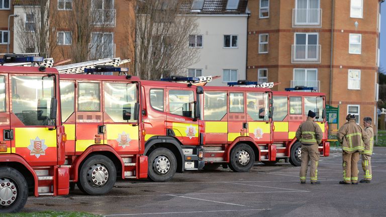 Fire engines and crew from across Essex wait just outside Jaywick
