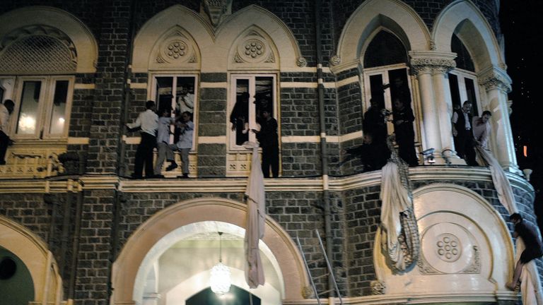 People use bed sheets to escape from the Taj Mahal Hotel in Mumbai after it come under attack during the Mumbai massacres
