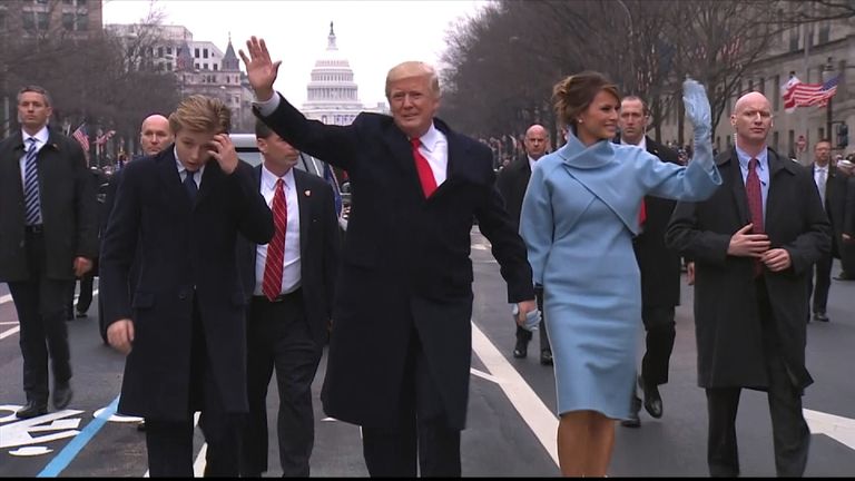 Donald Trump walks with wife Melania and son Barron during the parade