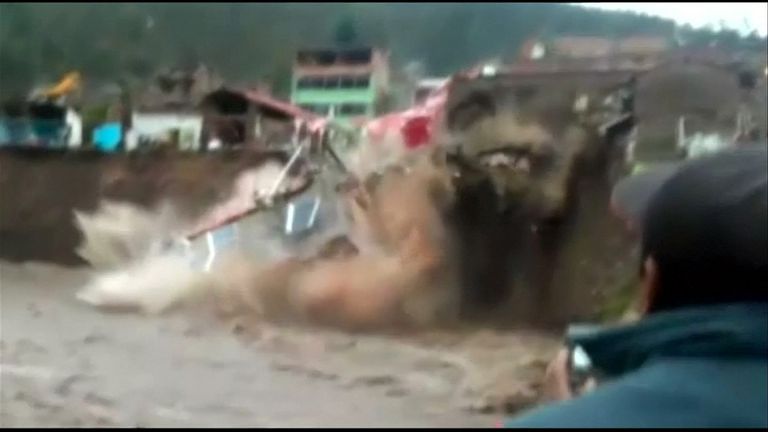 A hotel collapses into a river in Peru