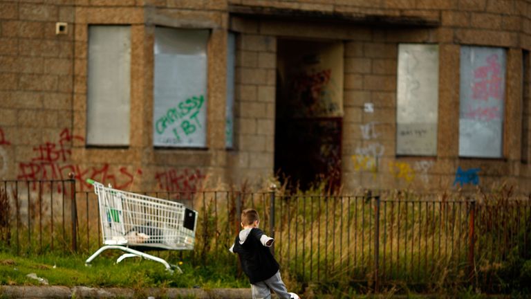 A young boy plays football in the street, September 30, 2008 in the Govan area of Glasgow, Scotland