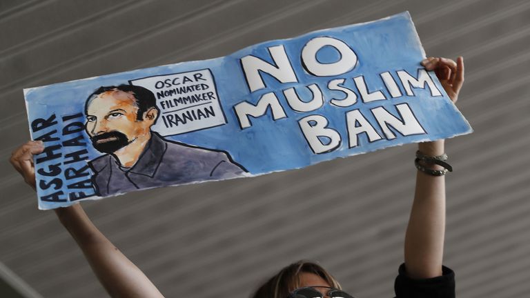 A woman holds a sign during a rally against a ban on Muslim immigration at San Francisco International Airport on January 28, 2017 in San Francisco, California. President Donald Trump signed an executive order Friday that suspends entry of all refugees for 120 days, indefinitely suspends the entries of all Syrian refugees, as well as barring entries from seven predominantly Muslim countries from entering for 90 days. (Photo by Stephen Lam/Getty Images)