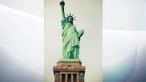 Activists hoist &#39;Refugees Welcome&#39; sign at the Statue of Liberty in New York
