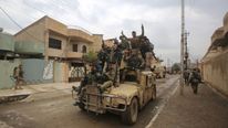 Iraqi special forces troops celebrate the retaking of east Mosul