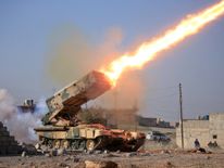 Iraqi army launch a rocket towards Islamic State militants near Ghozlani military complex, south of Mosul