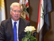 Sir Michael Fallon talks to reporters in Baghdad, Iraq