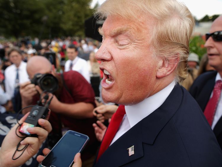 Republican presidential candidate Donald Trump (2nd L) talks with journalists during a rally against the Iran nuclear deal on the West Lawn of the U.S. Capitol September 9, 2015 in Washington, DC. Thousands of people gathered for the rally, organized by the Tea Party Patriots, which featured conservative pundits and politicians