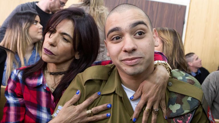 Elor Azaria sits with his mother as his sentencing hearing in Tel Aviv begins
