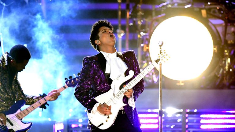 Bruno Mars wore a purple Prince-inspired suit as he performed a rendition of the late pop icon's song Let's Go Crazy at this year's Grammys