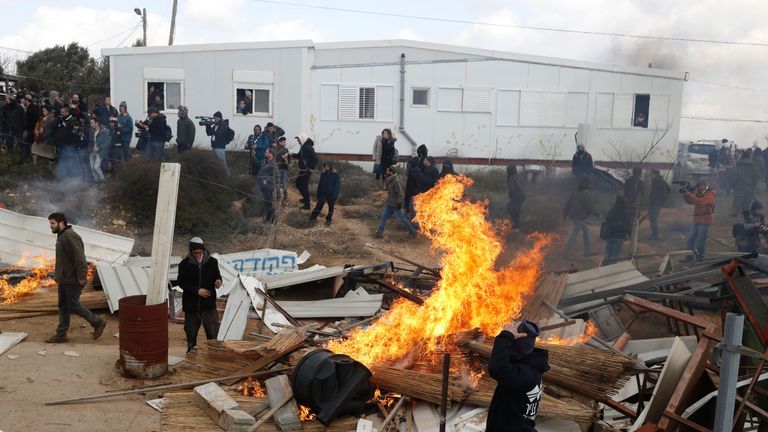 Israeli settlers set furniture on fire during scuffles with security forces