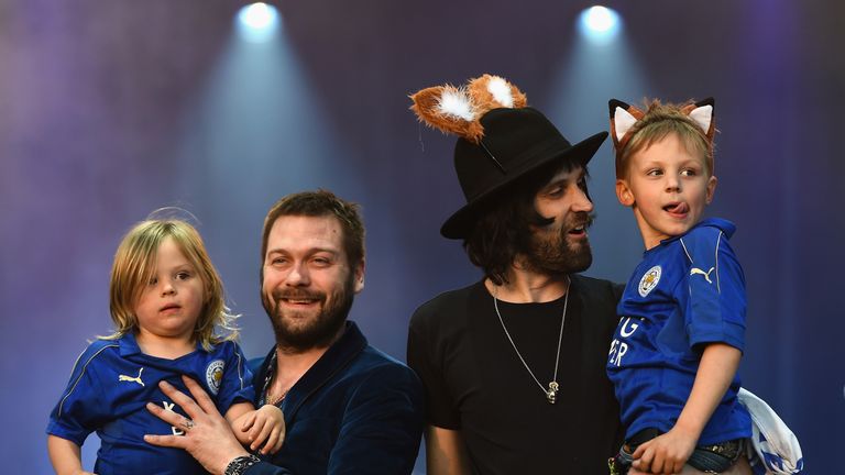 Kasabian and their children wave to the fans at the Leicester City bus parade