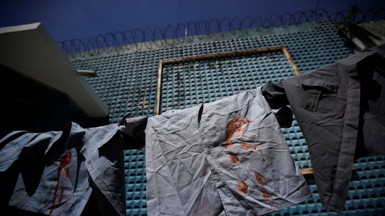 Family members hang police officers' uniforms in Rio in protest at the low pay