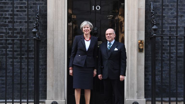 Theresa May greets Bernard Cazeneuve as he arrives in Downing Street
