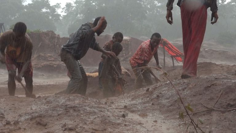 Dorsen is threatened with a beating as he works in heavy rain