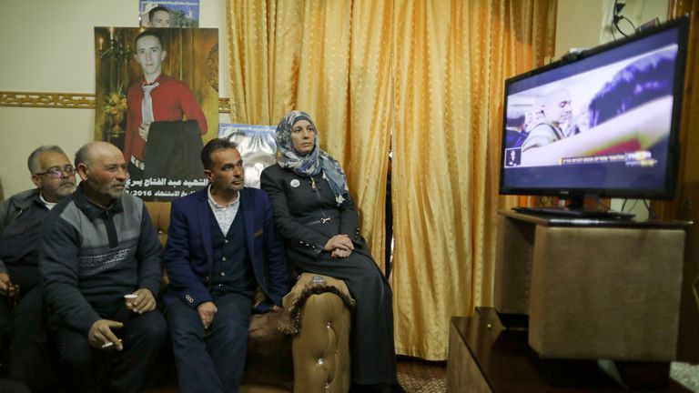 The family of Abd Elfatah Ashareef watch the TV broadcast of the sentencing