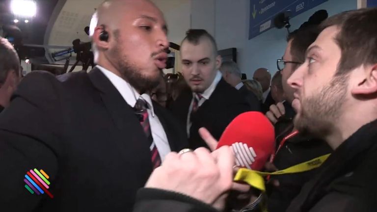 A reporter hustled away after trying to question Marine  Le Pen