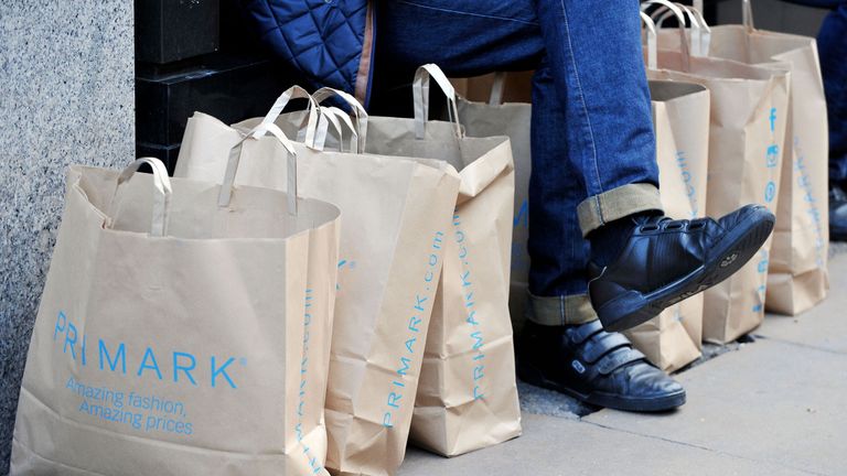 File photo dated 04/11/14 of a man surrounded by Primark bags in London