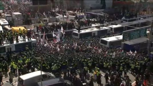 Police surround demonstrators outside the Constitutional Court in Seoul