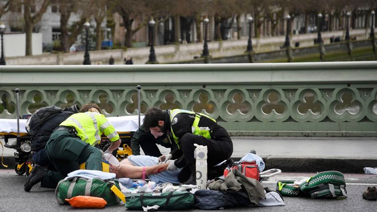 Paramedics treat an inured person after an incident on Westminster Bridge 