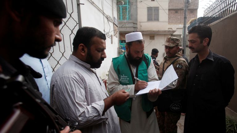 A census checker takes details from a resident of Peshawar, Pakistan
