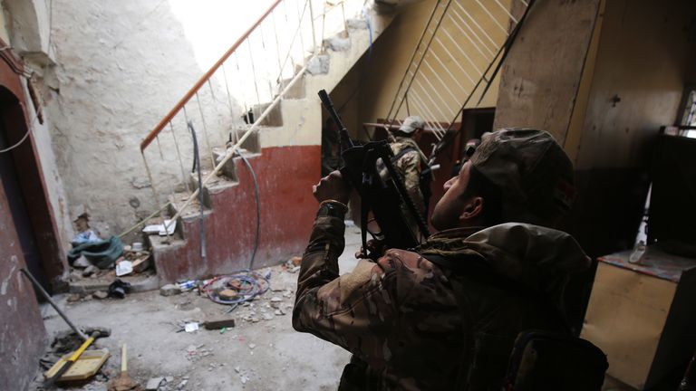 Iraqi forces, consisting of the Iraqi federal police and the elite Rapid Response Division, secure a building