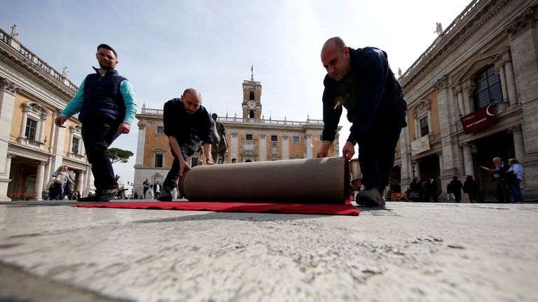 Workers lay a red carpet in front of the city hall "Campidoglio" (the Capitoline hill) as preparation for the meeting of EU leaders on the 60th anniversary of the Treaty of Rome