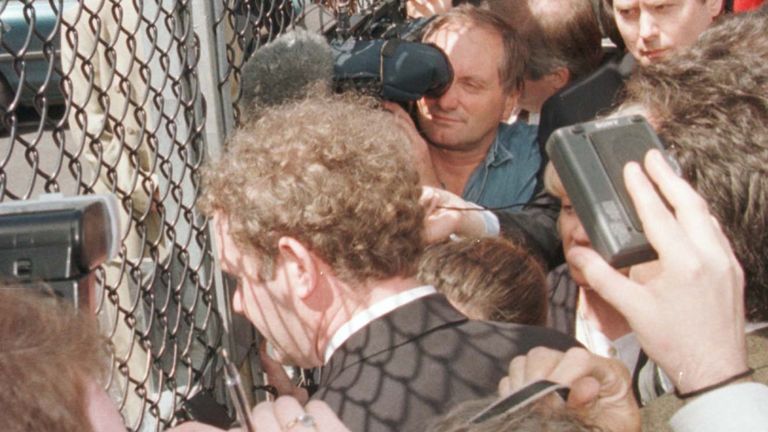Chief Negotiator for Sinn Fein Martin McGuinness shut out from the Ulster talks at Stormont speaks to the media through a fence, 1996