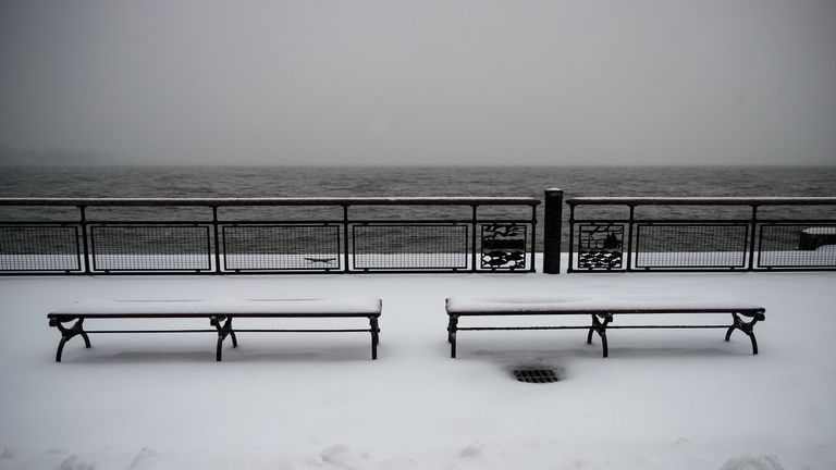 Benches covered in snow in Battery Park, New York City